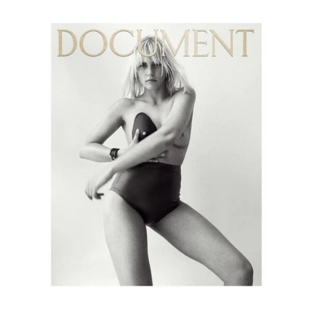 Black and white studio shot of a Caucasian woman posing in high-waisted bottoms, with a black bra, and the word 'DOCUMENT' at the top.