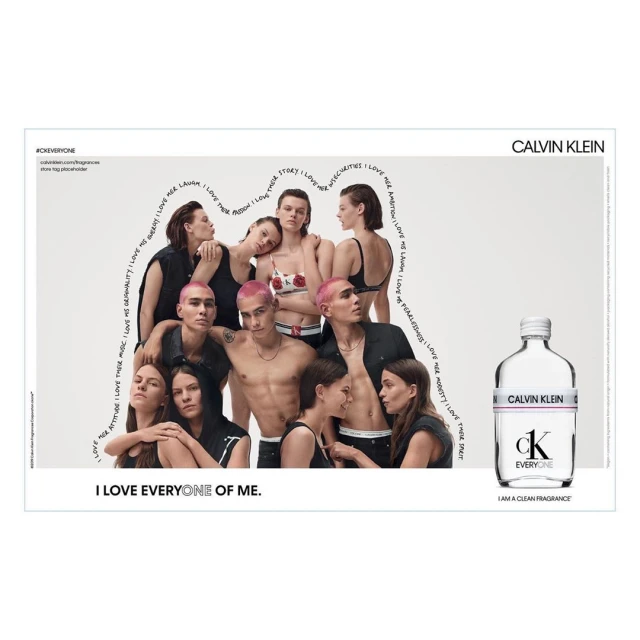 Calvin Klein ad features a group of young adults posing together with a Calvin Klein fragrance bottle. Light background and text accents.