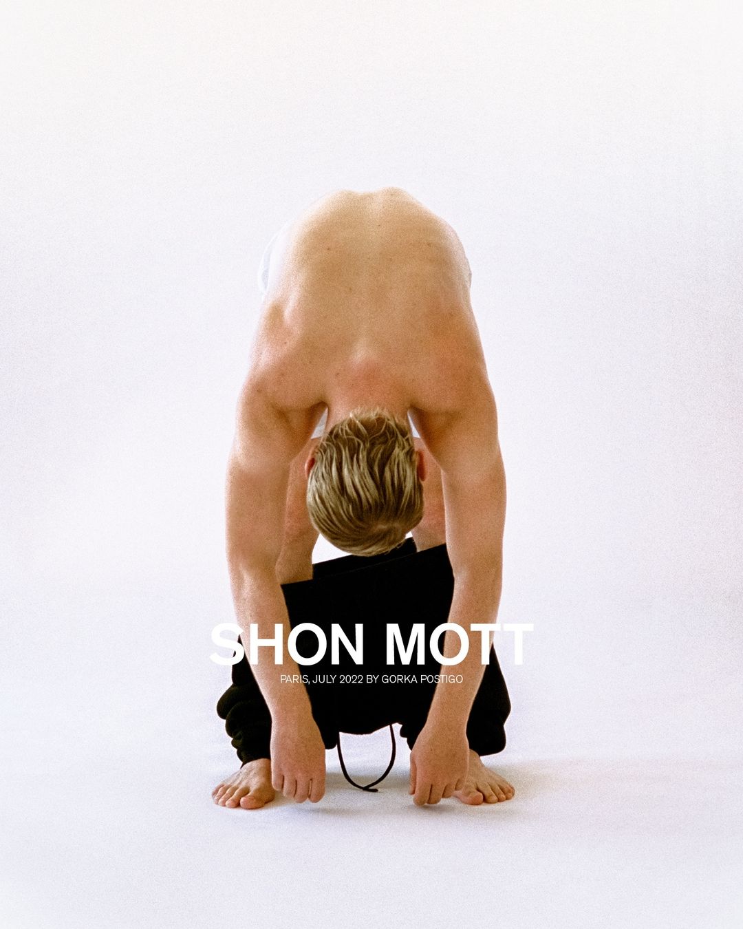 Nude man bends over, head between legs, wearing sweatpants; a fashion shot with the 'SHON MOTT' logo over a white background.