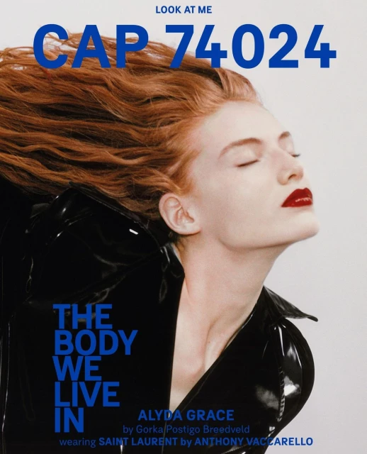 Fashion magazine cover featuring a fair-skinned woman with red hair, red lipstick, and a black patent leather jacket against a light gray background.