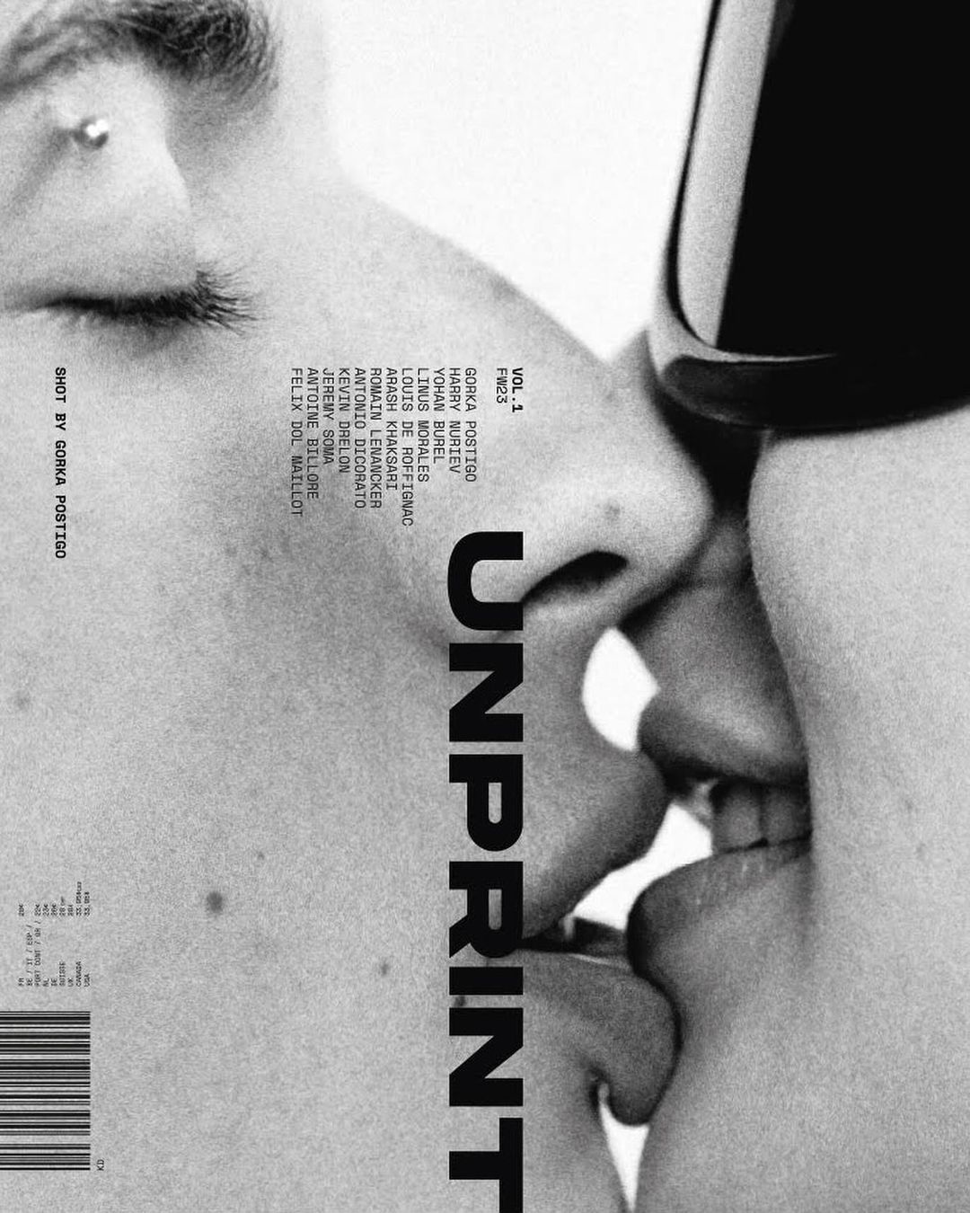 Close-up black and white photograph of two adult humans kissing each other, with stylized magazine text and a barcode.