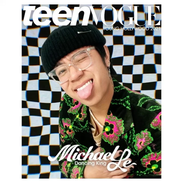 Teen Vogue cover featuring Michael Le with a winking expression, wearing a patterned jacket, in front of a black-and-white checkerboard background.