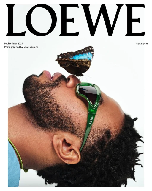 Loewe campaign featuring a man with a butterfly on his nose wearing Loewe sunglasses, set against a clean white backdrop with brand text.