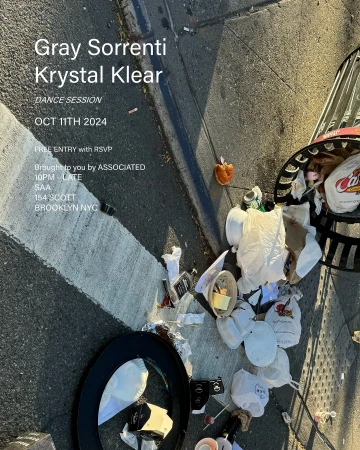 An outdoor advertisement displays event details for Gray Sorrenti & Krystal Klear, placed near a sidewalk area littered with trash and debris.
