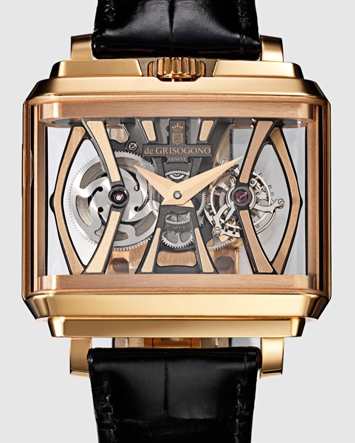 Luxury gold wristwatch by de Grisogono on a light background, showing intricate gears and black leather band, detailed studio shot.