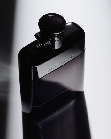 Black flask with Ralph Lauren logo on a white background, in a studio shot, for product advertising and luxurious men's accessories.