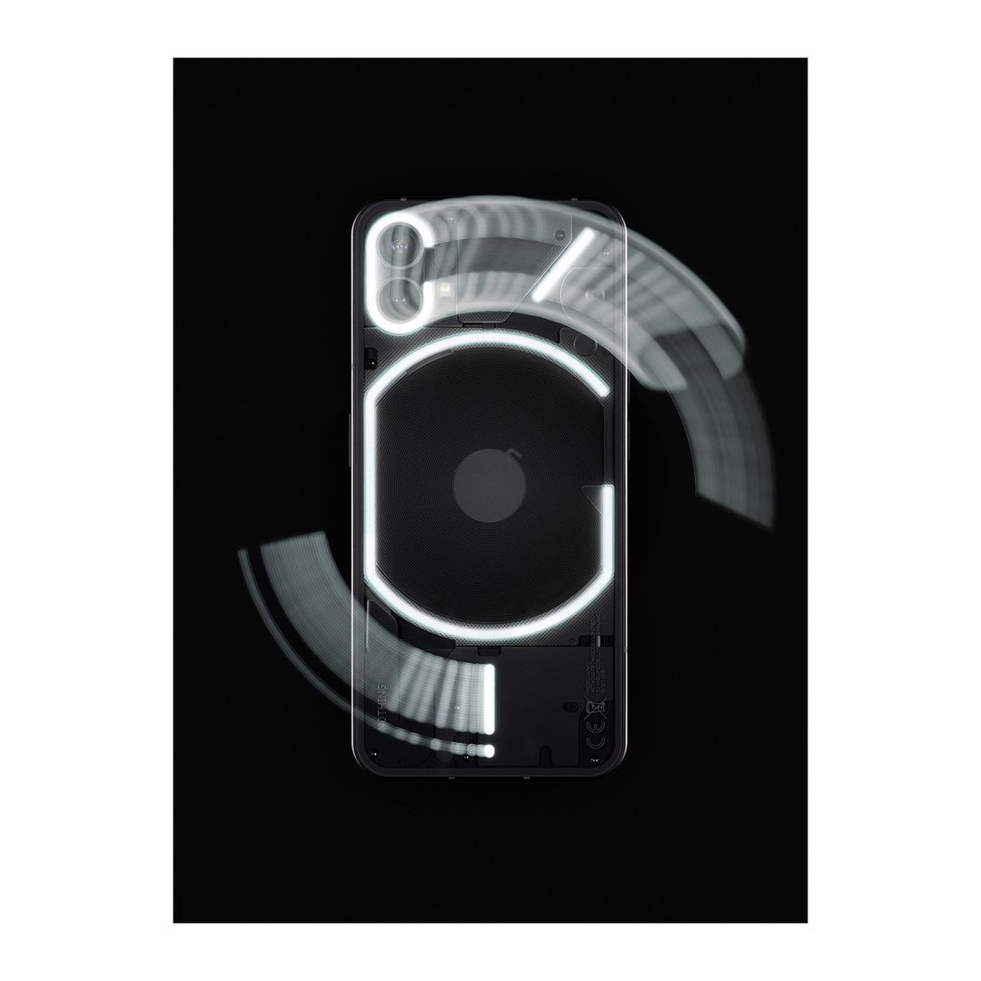 The back of a black smartphone is shown with illuminated glyphs. The phone is centered against a black background with motion blur effects.