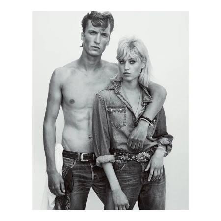 Black and white portrait of a shirtless man with dark hair and a blonde woman wearing a denim shirt, photographed by Gregory Harris.