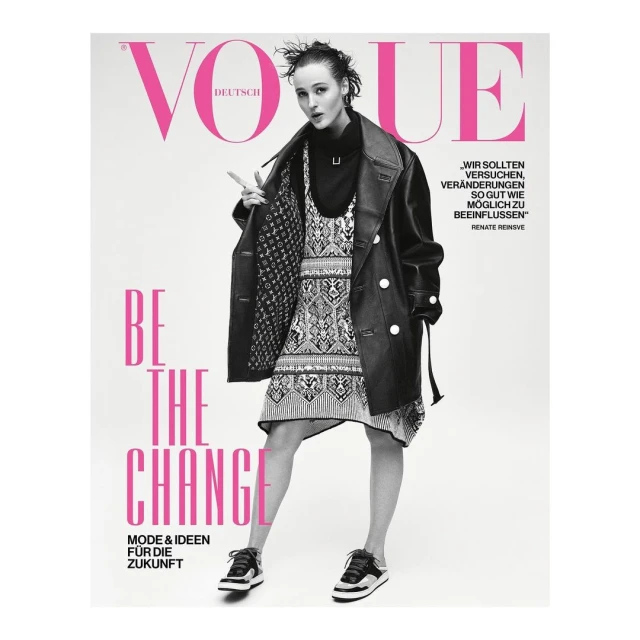 Vogue Deutsch cover featuring a young woman in a black coat and patterned dress, posing confidently against a clean, white backdrop.