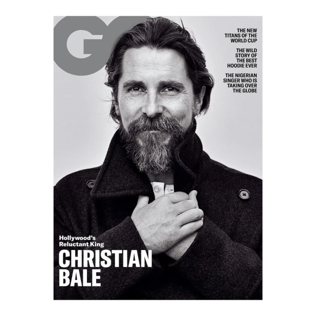 Black-and-white magazine cover featuring a portrait of actor Christian Bale in a dark coat, highlighted against a neutral background.