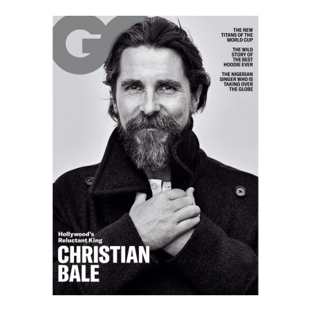 Black-and-white magazine cover featuring a portrait of actor Christian Bale in a dark coat, highlighted against a neutral background.