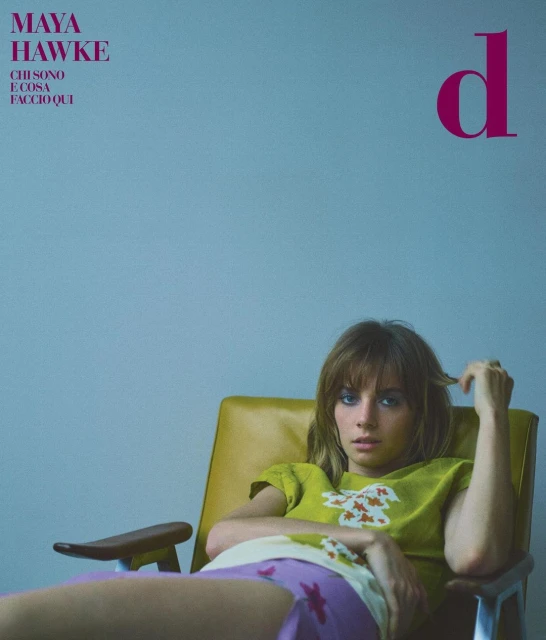 Magazine cover featuring Maya Hawke, an adult woman, reclining in a yellow mid-century chair with blue wall backdrop.
