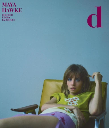 Magazine cover featuring Maya Hawke, an adult woman, reclining in a yellow mid-century chair with blue wall backdrop.