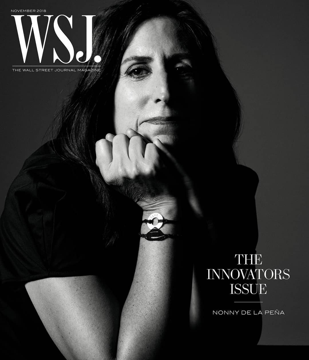 Black and white portrait of Nonny de la Peña on WSJ magazine cover, November 2018, looking at camera with hand near face, wearing bracelet.