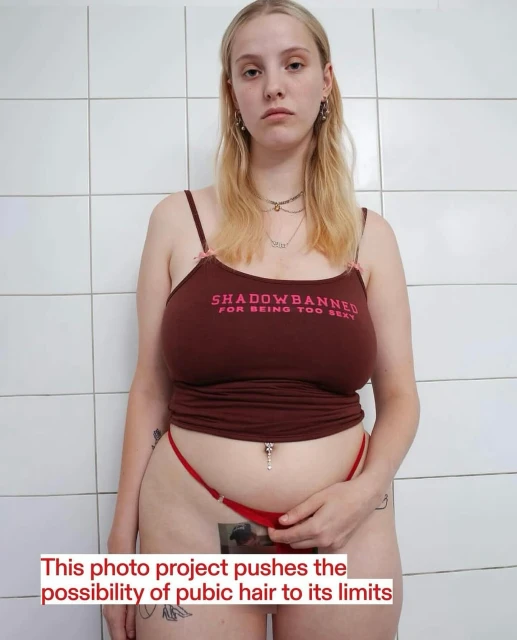 Adult female poses in front of a tiled wall wearing a brown tank top and a red thong. Image includes a print on the thong.