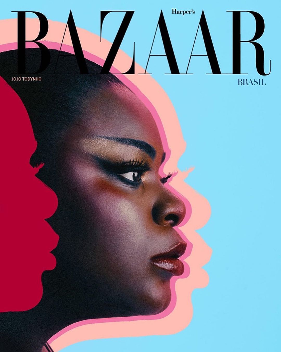 Close-up profile of a Black woman's face, magazine cover with vibrant pink and blue shadowing, 'Bazaar' masthead. Beauty and fashion editorial.