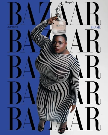 Magazine cover featuring plus-size woman in zebra-striped dress balancing perfume bottle on her head against blue and white background.