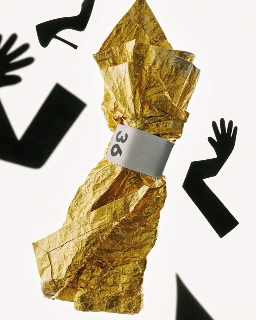 Abstract composition with gold foil, a silver band labeled '36', and black arm silhouettes with a shoe and hand on a white backdrop.