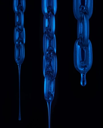 Three blue translucent chains with drips hang against a stark black background in a studio product shot with cool lighting.