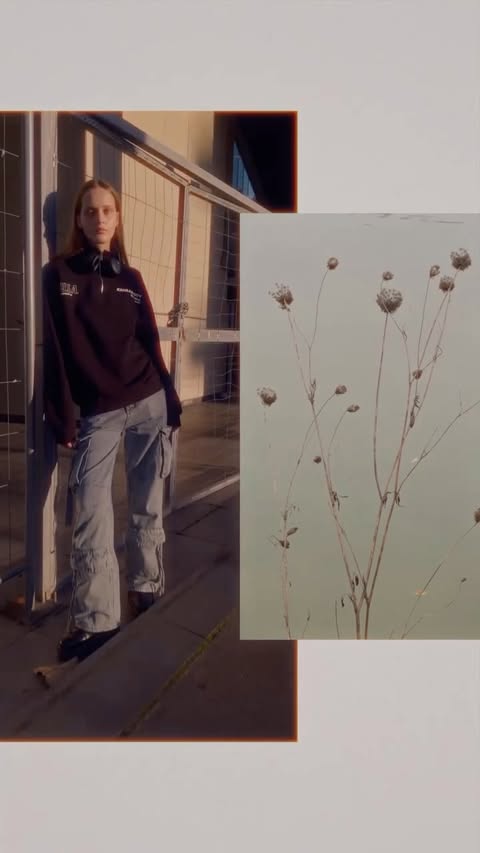 Adult woman in a maroon sweatshirt and light blue cargo pants stands outdoors with dried flower arrangement and geometric designs.