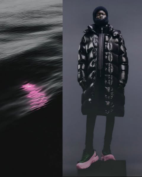 Fashion editorial shot of an African American model wearing a glossy black puffer coat, cap, and color-blocked platform sneakers against a dark backdrop.