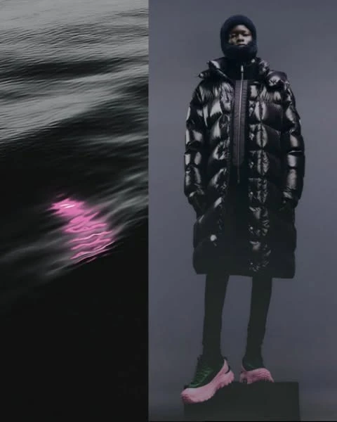 Fashion editorial shot of an African American model wearing a glossy black puffer coat, cap, and color-blocked platform sneakers against a dark backdrop.