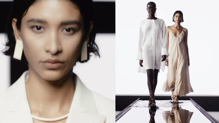 Two women in white and neutral dresses walk on a reflective runway in a fashion show. Close-up of one woman in a white jacket and earrings.