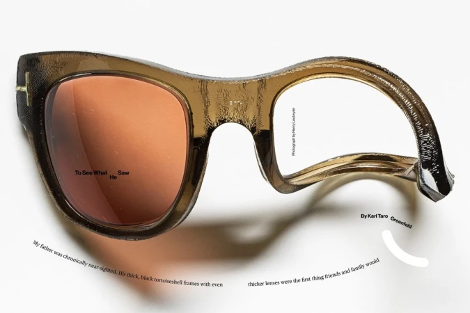 Brown-tinted eyewear with one lens and black tortoiseshell frames is displayed against a plain white background, with visible text.