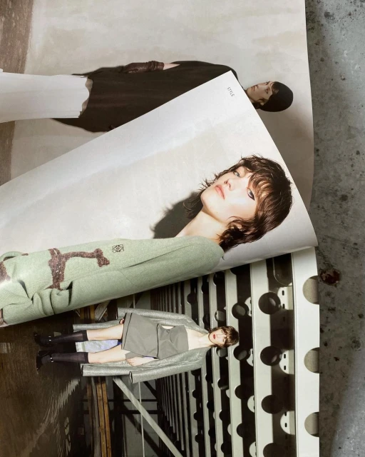 Fashion editorial featuring a woman with brown hair in a green jacket, with other fashion shots in the background, creating a layered visual.