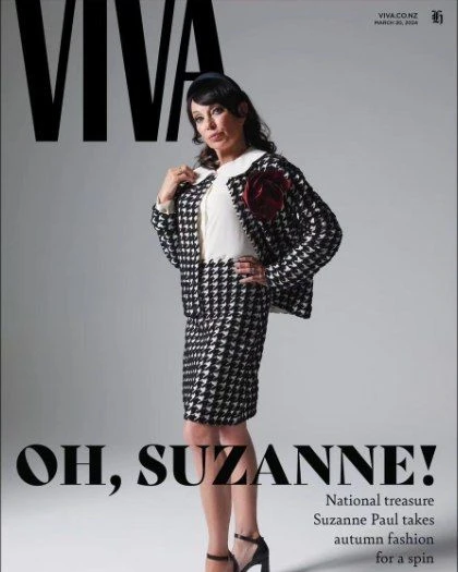 Magazine cover featuring a fashionable woman in a black and white houndstooth skirt suit, posing against a grey backdrop with bold title text.
