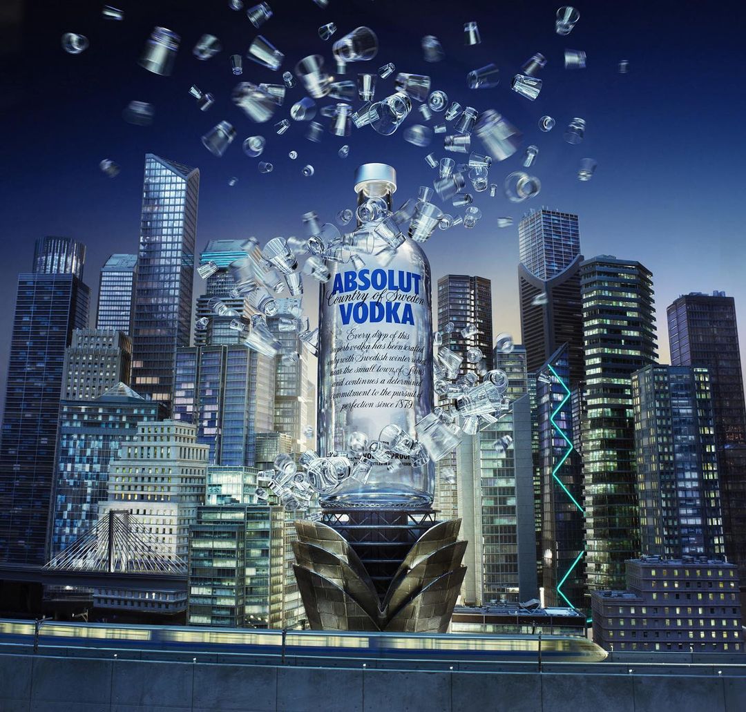 An Absolut Vodka bottle artfully presented within a cityscape, surrounded by shattered glass, creating a surreal, modern visual composition.