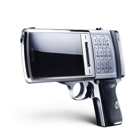 Silver cell phone in the shape of a handgun on a white background. The hybrid device combines a cell phone with a handgun's design.
