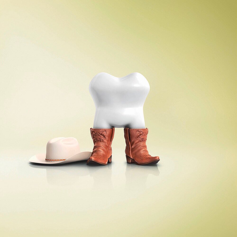 Whimsical dental concept: A cartoon tooth wearing cowboy boots and a cowboy hat on a gradient yellow background.