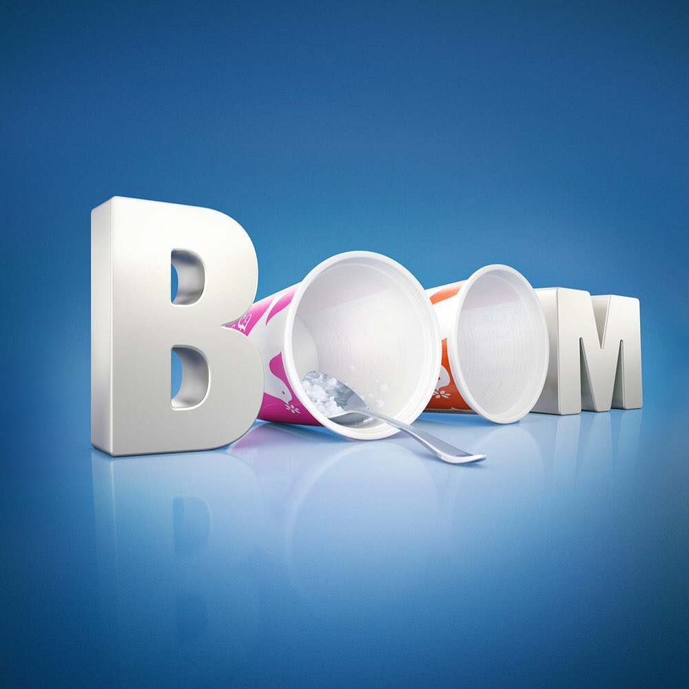 Still life featuring empty ice cream cups and a spoon, alongside block letters spelling 'BOM,' set against a gradient blue background.