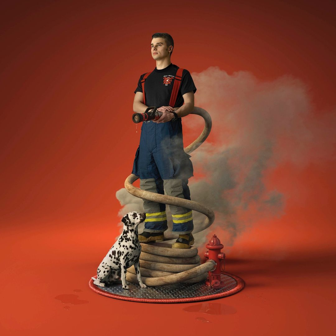 Firefighter in uniform holds hose, with dalmatian and fire hydrant, stands on a metal platform with smoke against an orange backdrop.
