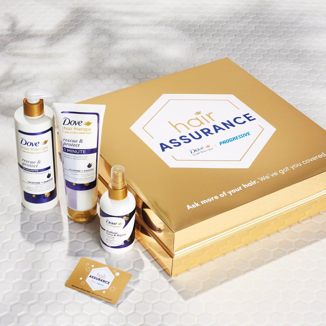 Dove hair therapy products: rescue and protect shampoo, conditioner, and hairspray, displayed with gold box and business card.