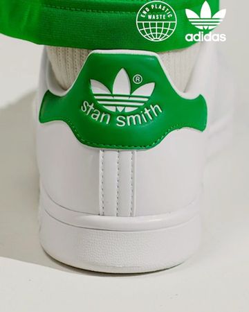 Back view of a white and green Adidas Stan Smith sneaker with Adidas logo and text 'stan smith' on a clean, light background.