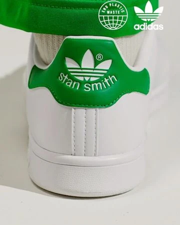 Back view of a white and green Adidas Stan Smith sneaker with Adidas logo and text 'stan smith' on a clean, light background.