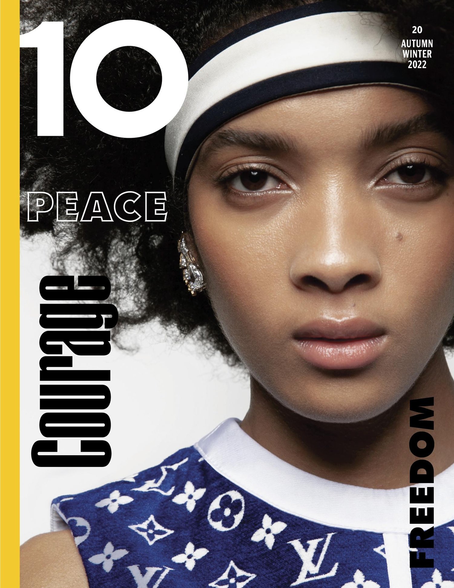 Close-up of a young woman with dark hair and a headband, adorned with 'Courage,' 'Peace,' and 'Freedom' typography on a fashion magazine cover.