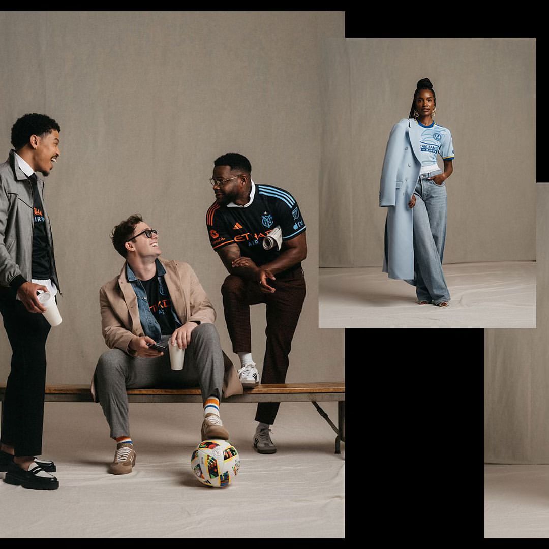 Four people are posed in a light studio with a soccer ball near a wood bench wearing soccer jerseys and casual wear. Fashion shoot.