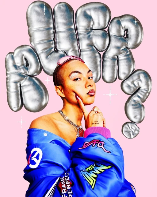 Woman in blue jacket poses with silver balloon letters on pink backdrop, showcasing fashion, makeup, and edgy style.