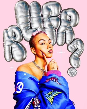 Woman in blue jacket poses with silver balloon letters on pink backdrop, showcasing fashion, makeup, and edgy style.