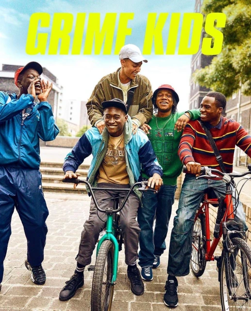 Five young men pose on bikes outdoors with an urban cityscape backdrop, bright yellow text overlay, and casual fashion.