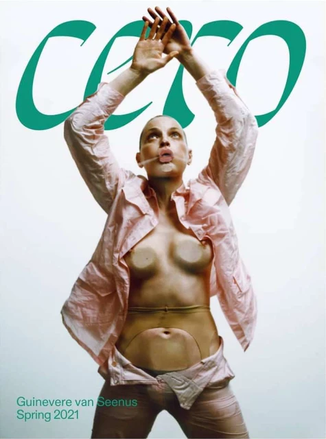 Magazine cover featuring a woman in a pink shirt with hands raised, against a light background with green lettering and brand name.