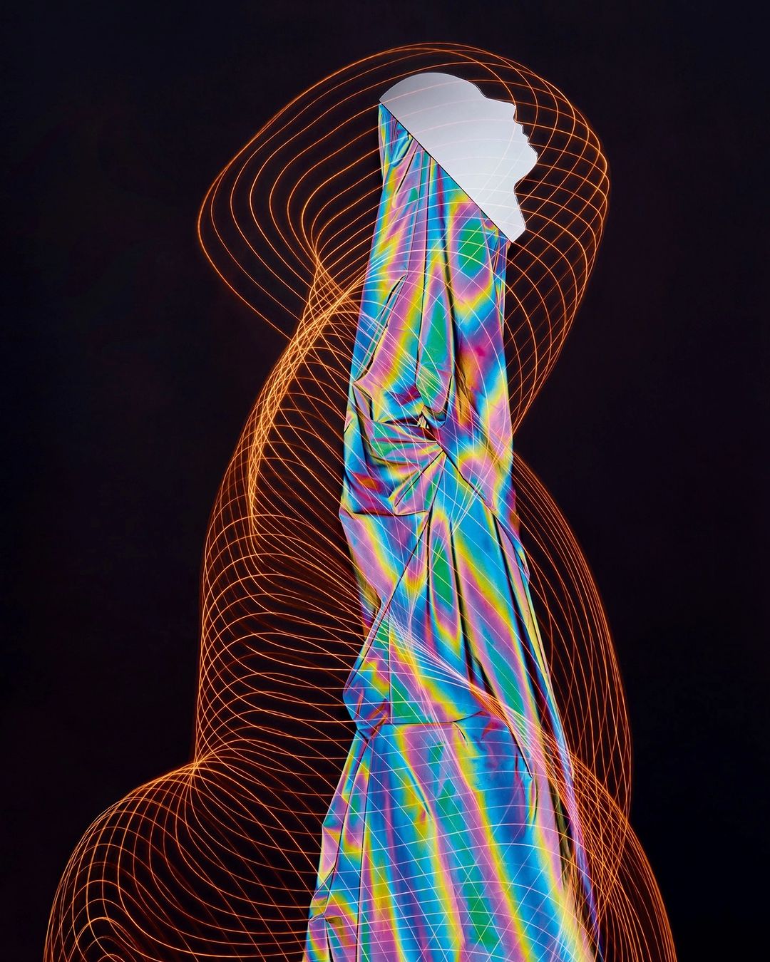 Abstract artwork featuring a mannequin head draped with iridescent fabric against a dark background with orange line art.