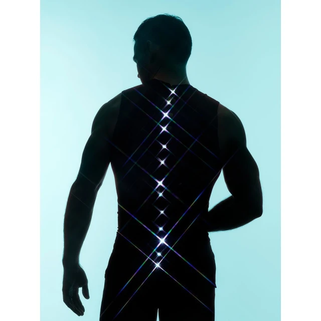 Silhouette of muscular adult male in tank top against a light blue background with stylized spinal column with symmetrical starbursts.