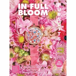Pink leather luxury wristwatch set against a dense arrangement of pink flowers and blossoms