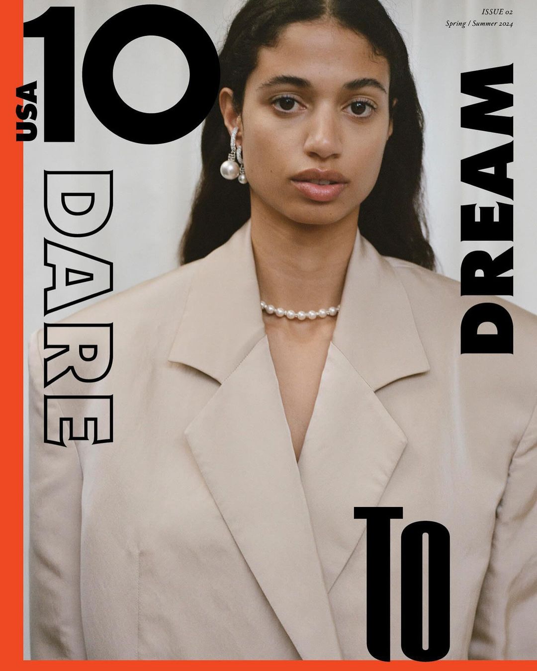 Magazine cover featuring a stylish woman in a blazer, accessorized with pearl jewelry, embodying elegance and modern fashion.