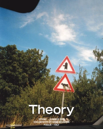 Traffic sign with cow symbol in a rural area under a blue sky, seen from inside a car, with trees and greenery in the background.