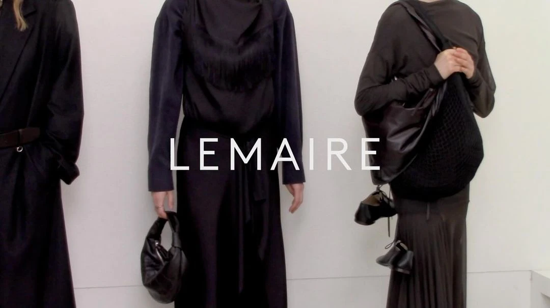 Three fashion models showcase black outfits and stylish handbags against a neutral backdrop, emphasizing minimalist style and luxury accessories.